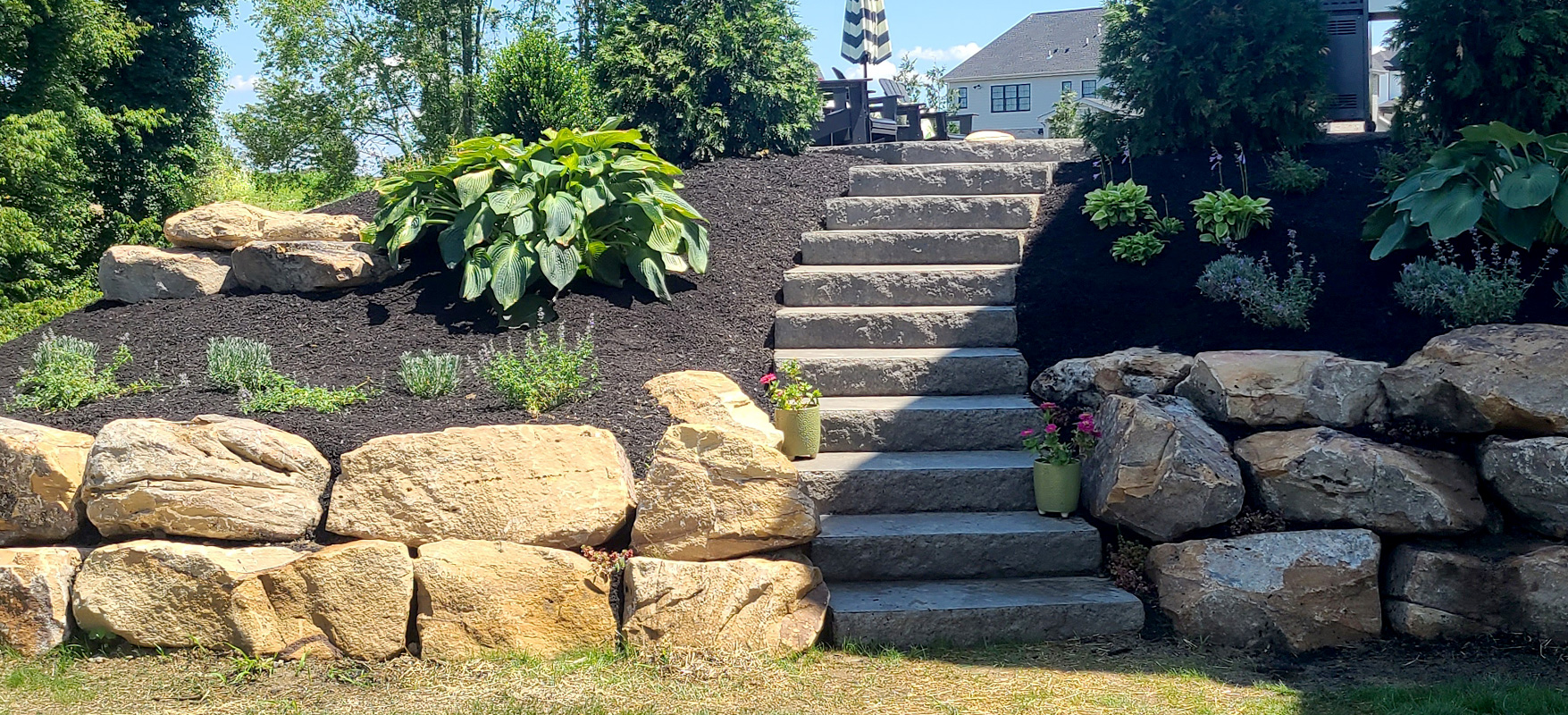 McGinn Landscaping - Hardscaping Boulder Wall and Concrete Stairs